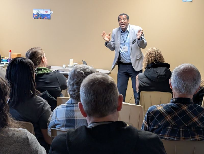 black man in blue suit expressive talk