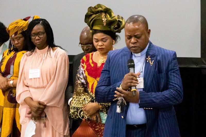 man and women bowed in prayer