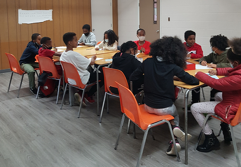 youth working together at a long table