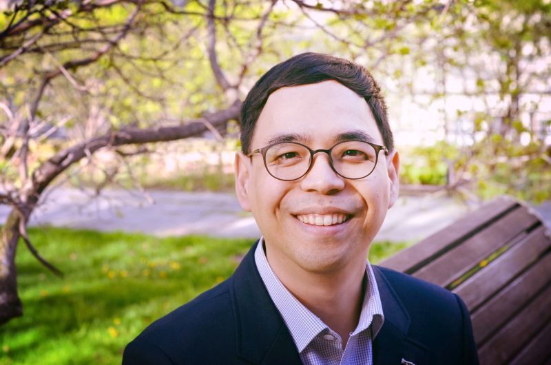 smiling man outside wearing glasses