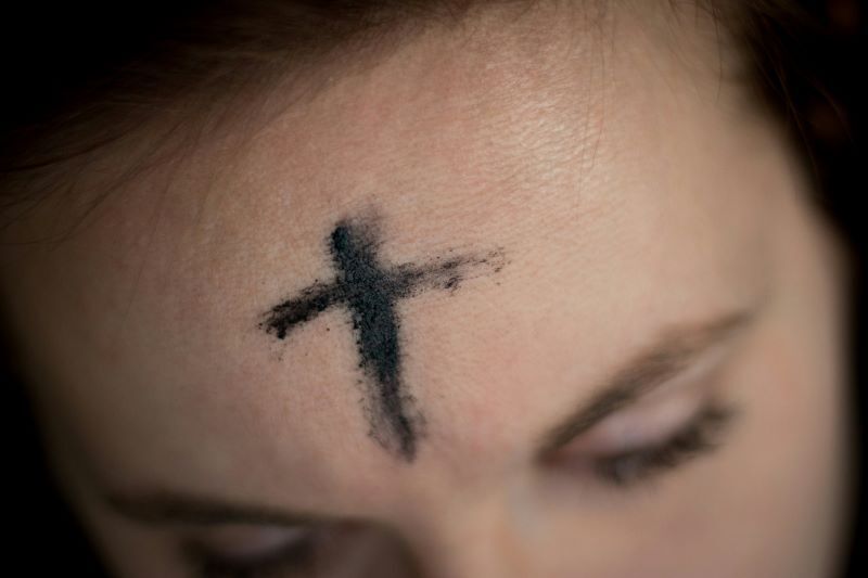 forehead with a cross made of ash