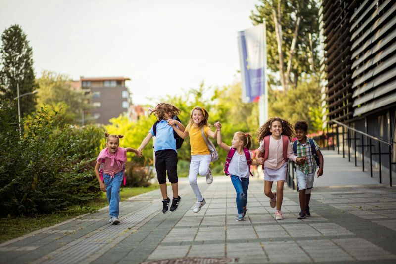school children running and smiling 