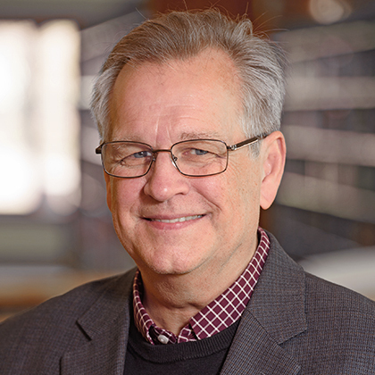 smiling white man with glasses