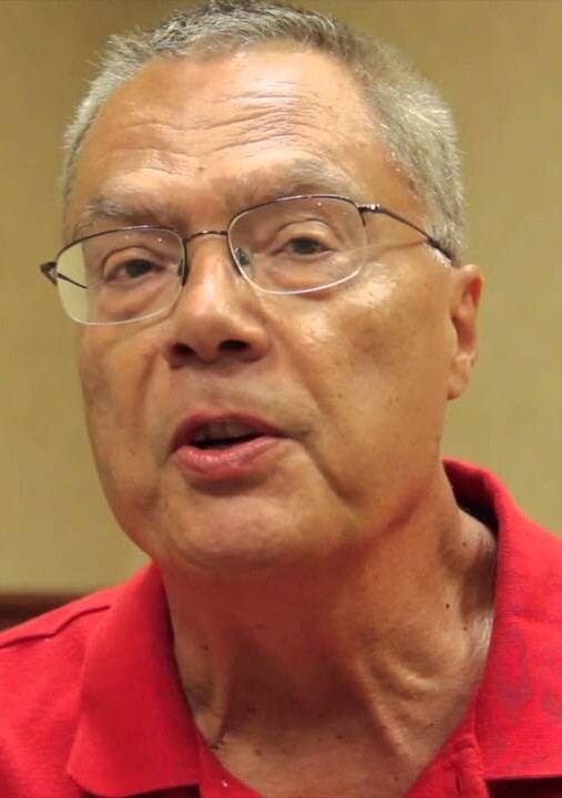 man in red shirt speaking