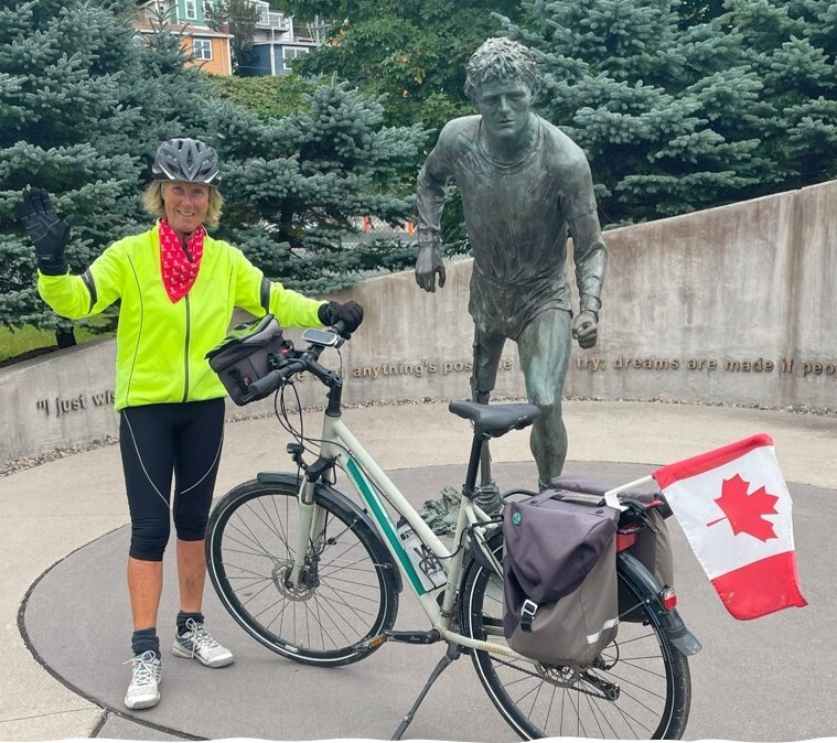 woman biker next to Terry Fox monument
