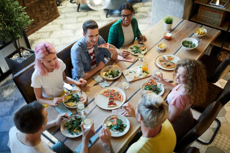 people smiling around a dinner table