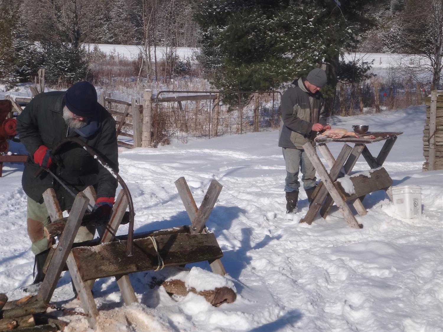 two men working in the winter on sawhorses