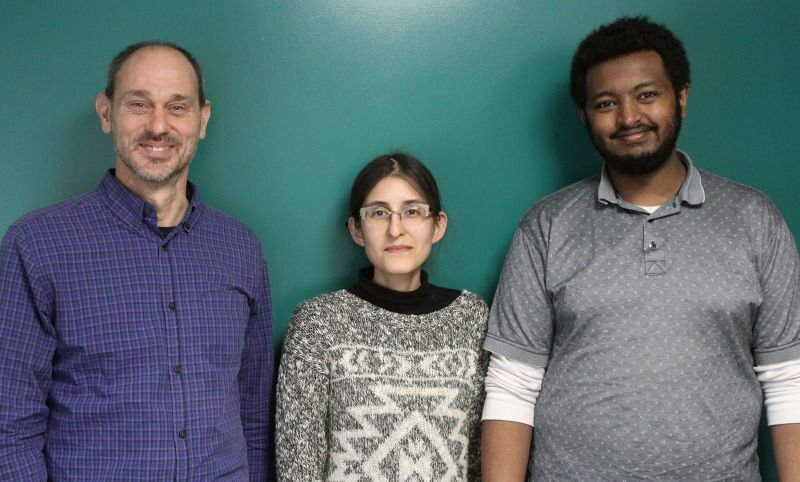 three people smiling