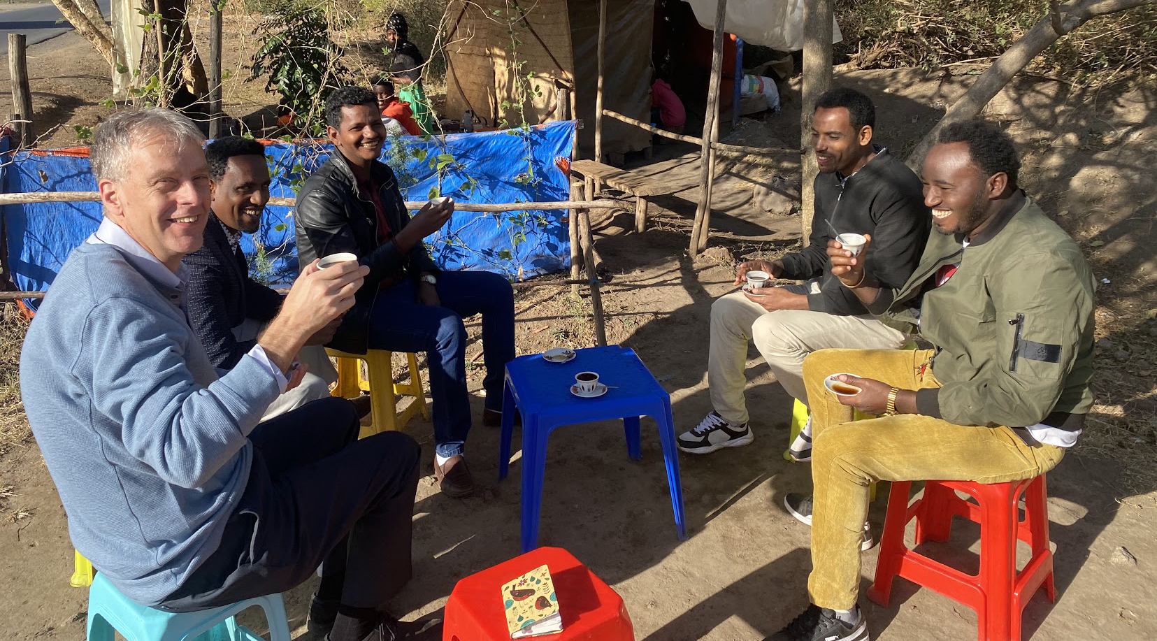Gentlemen in Ethiopia sitting outside having coffee